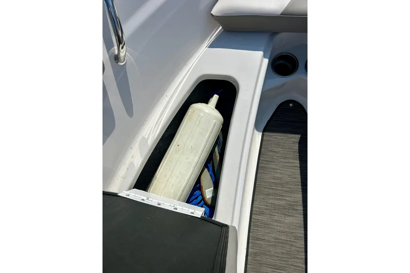 Slide: The Image of Storage compartment in a 2017 Four Winns 180 Horizon boat with a fender inside. - 21