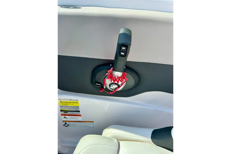 Slide: The Image of Throttle control lever on a 2017 Four Winns 180 Horizon boat interior. - 29
