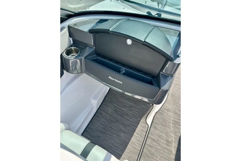 Slide: The Image of 2017 Four Winns 180 Horizon boat interior with glove compartment and cup holder. - 34