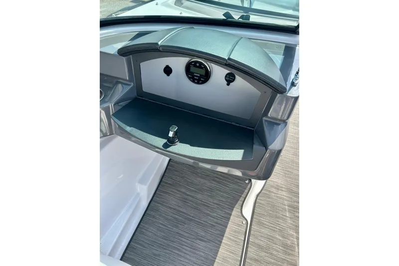 Slide: The Image of 2017 Four Winns 180 Horizon boat dashboard with storage compartment and sleek design. - 35
