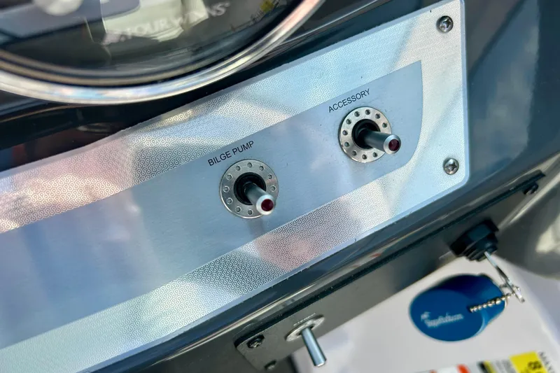 Slide: The Image of Control panel of a 2017 Four Winns 180 Horizon boat with bilge pump and accessory switches. - 38