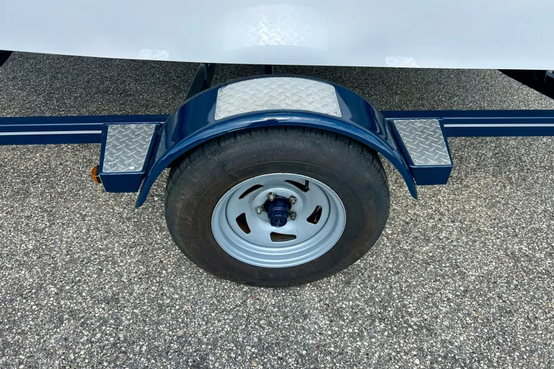 Slide: The Image of Trailer wheel of a 2017 Four Winns 180 Horizon boat on asphalt. - 45