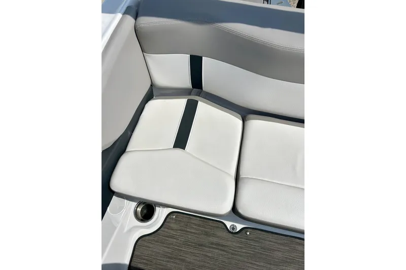 Slide: The Image of 2017 Four Winns 180 Horizon boat interior seating with cup holder, featuring white and gray upholstery. - 49