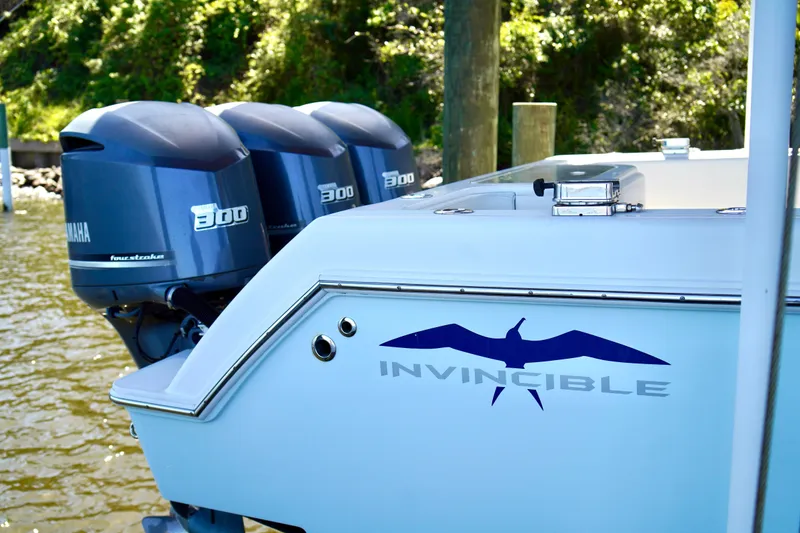 The Image of 2019 Invincible 36 Open Fisherman with triple Yamaha 300 engines docked by water. - 0