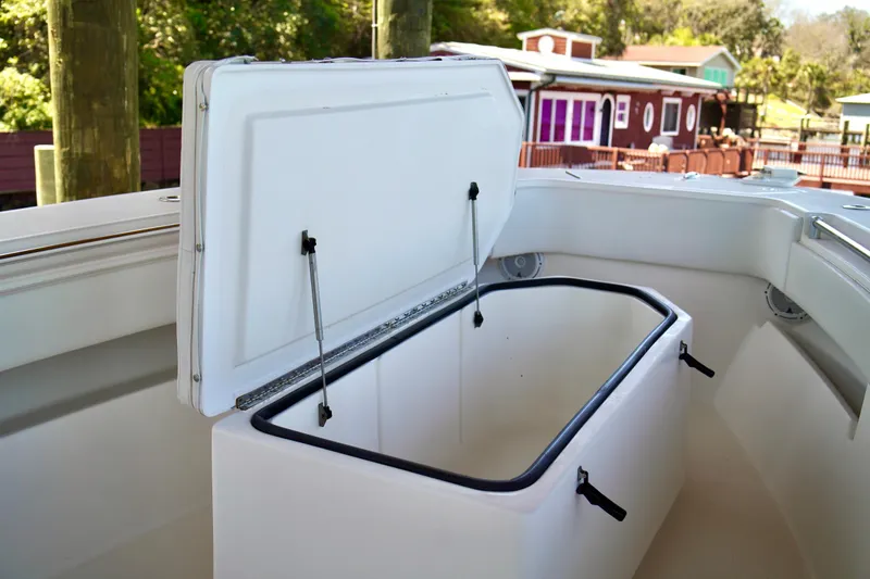 Slide: The Image of Open storage compartment on 2019 Invincible 36 Open Fisherman boat, dockside view. - 12