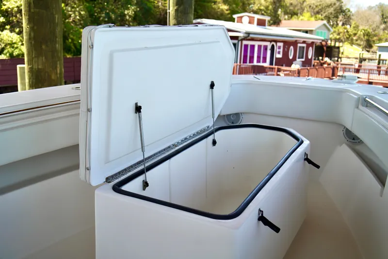Slide: The Image of Open storage compartment on 2019 Invincible 36 Open Fisherman boat, dockside view. - 13
