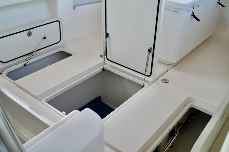 Slide: The Image of 2019 Invincible 36 Open Fisherman boat storage compartments and seating area. - 15