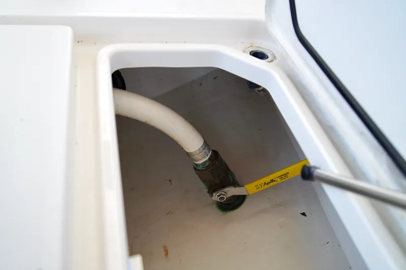 Slide: The Image of 2019 Invincible 36 Open Fisherman boat compartment with hose and valve. - 17