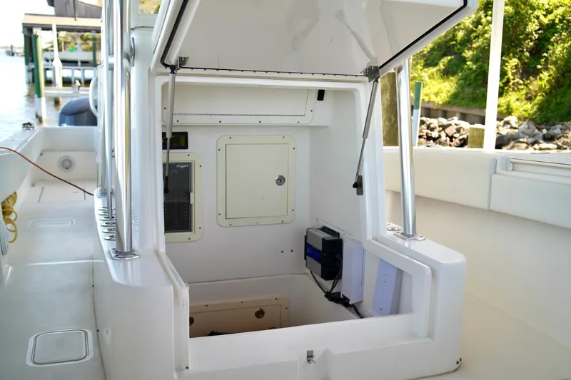 Slide: The Image of 2019 Invincible 36 Open Fisherman boat interior with open storage compartment and control panel. - 20