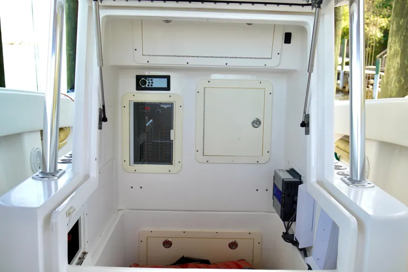 Slide: The Image of 2019 Invincible 36 Open Fisherman boat interior with control panel and storage compartments. - 21