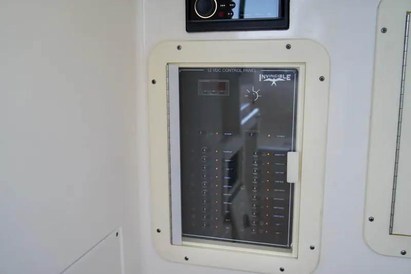 Slide: The Image of 2019 Invincible 36 Open Fisherman control panel with switches and indicators. - 22