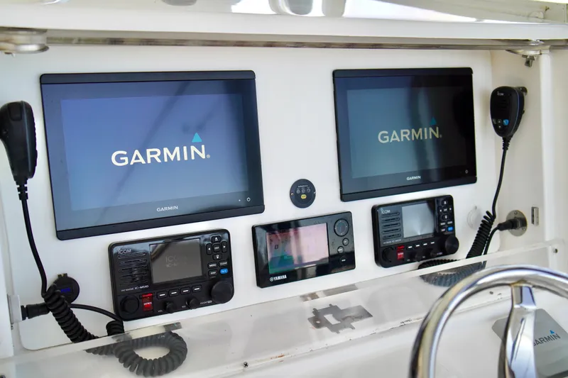 Slide: The Image of 2019 Invincible 36 Open Fisherman dashboard with Garmin navigation displays and communication equipment. - 31