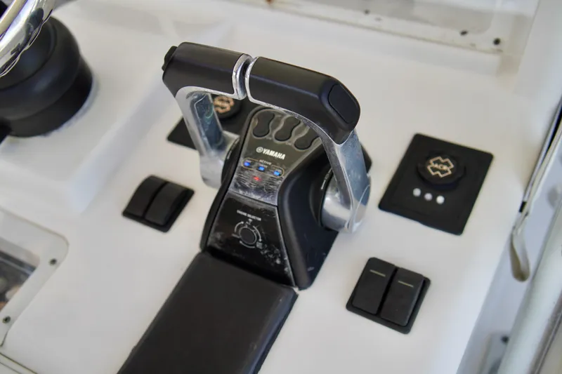Slide: The Image of Throttle controls on a 2019 Invincible 36 Open Fisherman boat dashboard. - 40