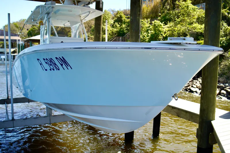 Slide: The Image of 2019 Invincible 36 Open Fisherman boat docked, showcasing sleek design and white hull. - 5