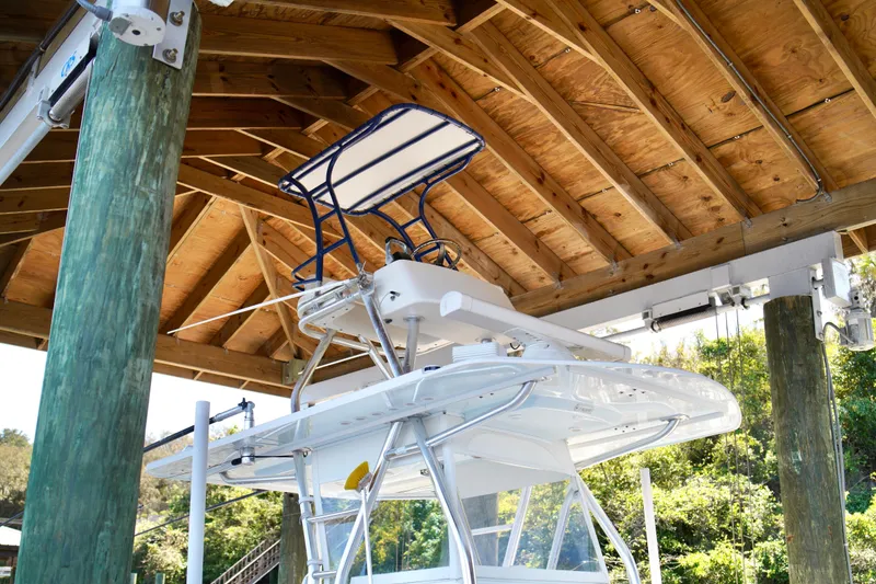 Slide: The Image of 2019 Invincible 36 Open Fisherman boat under wooden dock roof. - 51