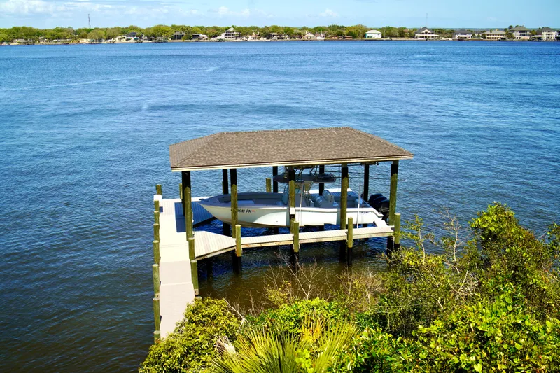 Slide: The Image of 2019 Invincible 36 Open Fisherman docked under a covered pier on a serene lake. - 69