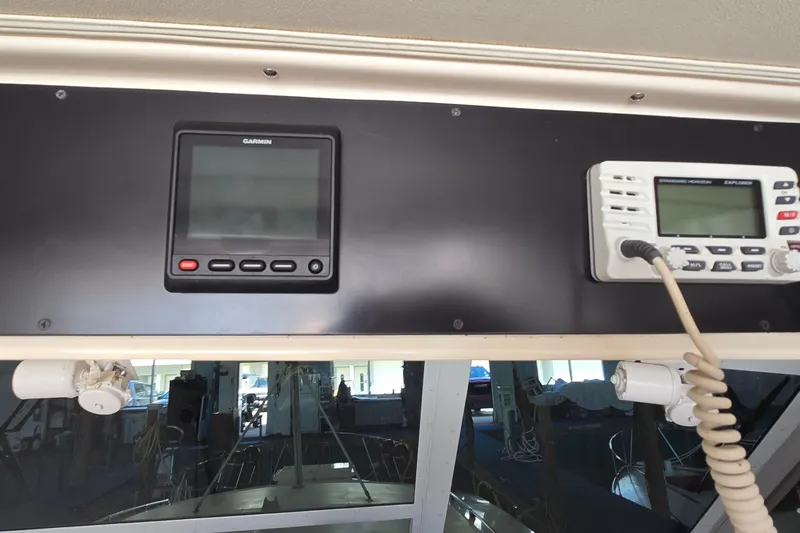 Slide: The Image of 1977 Bertram 42 Flybridge Motor Yacht dashboard with Garmin and radio equipment. - 10