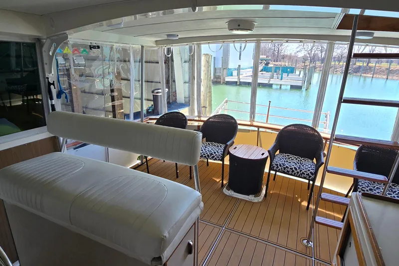 Slide: The Image of 1977 Bertram 42 Flybridge Motor Yacht interior with seating and water view. - 13