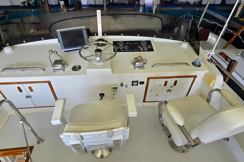 Slide: The Image of Cockpit of a 1977 Bertram 42 Flybridge Motor Yacht with steering wheel and controls. - 19
