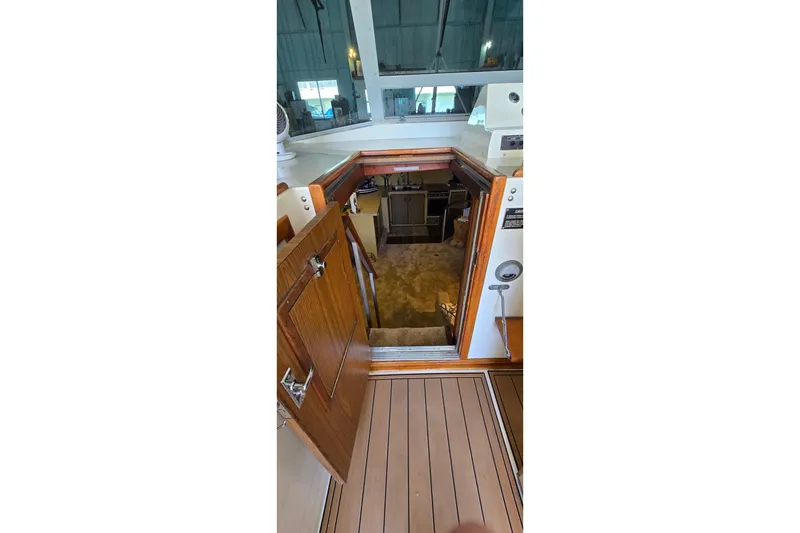 Slide: The Image of Interior view of 1977 Bertram 42 Flybridge Motor Yacht, showcasing wooden door and cabin entrance. - 25