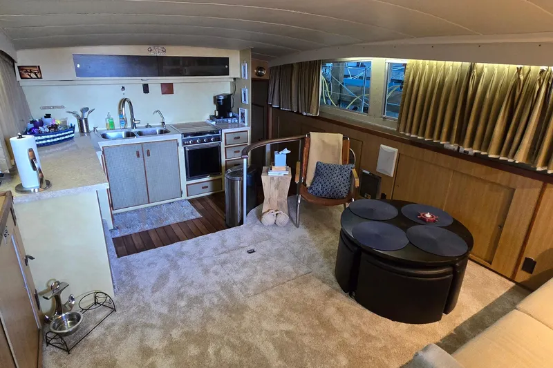 Slide: The Image of Interior of a 1977 Bertram 42 Flybridge Motor Yacht with kitchen and seating area. - 26