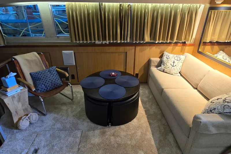 Slide: The Image of Interior of 1977 Bertram 42 Flybridge Motor Yacht with cozy seating and nautical decor. - 27