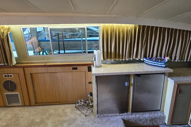 Slide: The Image of Interior of 1977 Bertram 42 Flybridge Motor Yacht with wood paneling and countertop. - 29