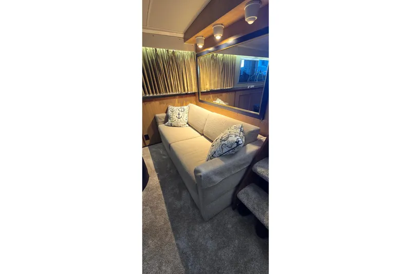Slide: The Image of Interior of 1977 Bertram 42 Flybridge Motor Yacht with cozy sofa and nautical decor. - 30