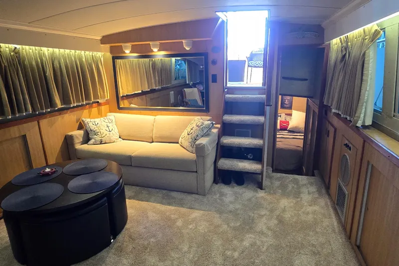 Slide: The Image of Interior of 1977 Bertram 42 Flybridge Motor Yacht with cozy seating and elegant decor. - 31