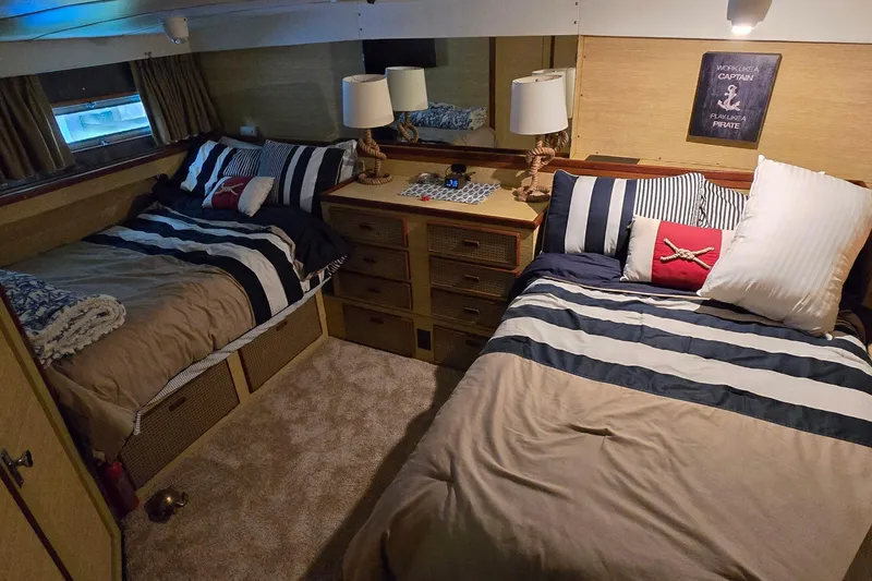 Slide: The Image of Cozy cabin interior of 1977 Bertram 42 Flybridge Motor Yacht with twin beds and nautical decor. - 32