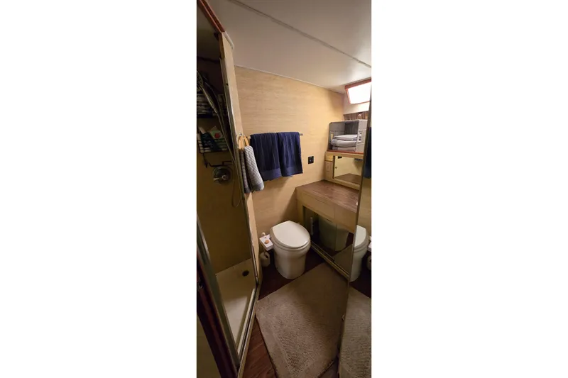 Slide: The Image of Bathroom interior of 1977 Bertram 42 Flybridge Motor Yacht, featuring shower and vanity. - 36