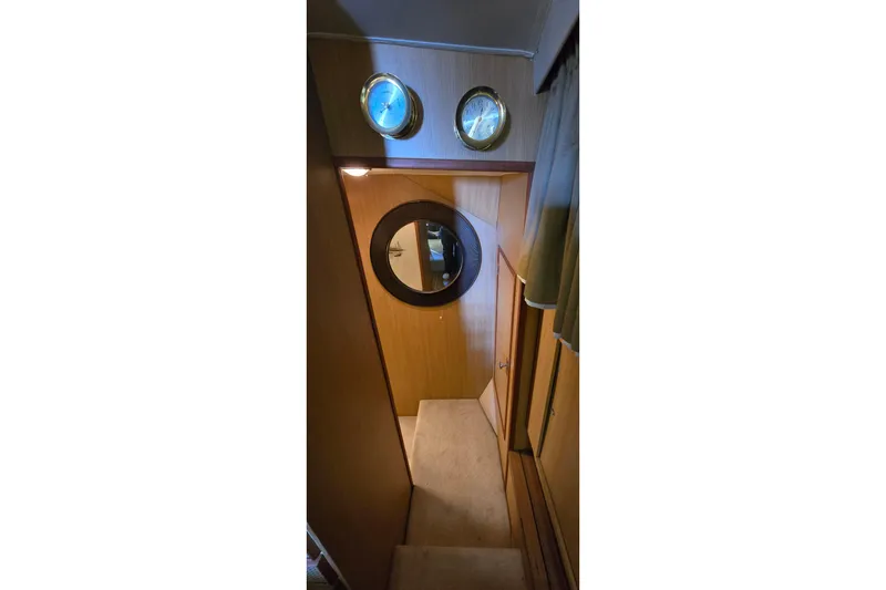 Slide: The Image of Interior of 1977 Bertram 42 Flybridge Motor Yacht with wooden paneling and portholes. - 42