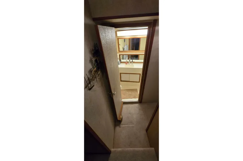 Slide: The Image of Interior view of a 1977 Bertram 42 Flybridge Motor Yacht, showing a bathroom entrance. - 43