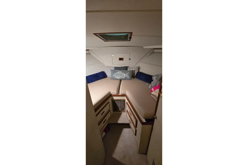 Slide: The Image of Cozy cabin interior of 1977 Bertram 42 Flybridge Motor Yacht with twin beds and storage. - 44