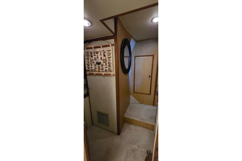 Slide: The Image of Interior of 1977 Bertram 42 Flybridge Motor Yacht with wooden paneling and nautical decor. - 50