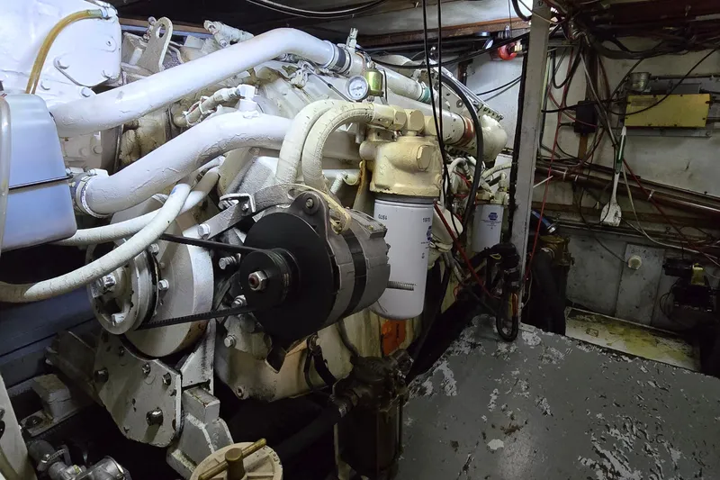 Slide: The Image of Engine room of a 1977 Bertram 42 Flybridge Motor Yacht, showcasing mechanical components. - 56