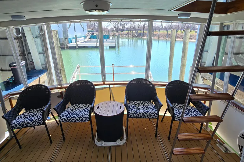 Slide: The Image of 1977 Bertram 42 Flybridge Motor Yacht aft deck with seating and water view. - 6