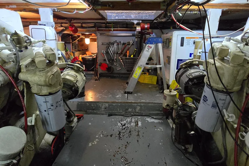 Slide: The Image of Engine room of a 1977 Bertram 42 Flybridge Motor Yacht with tools and equipment. - 60