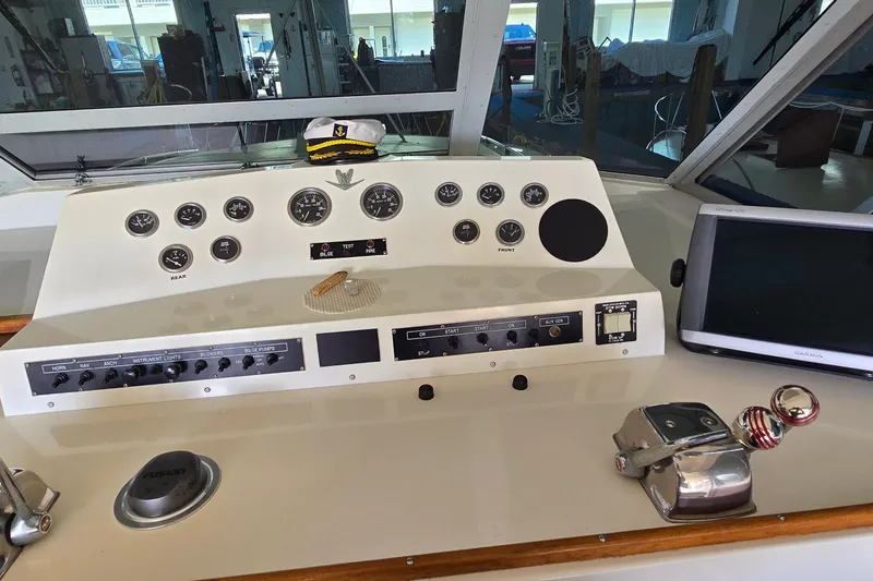 Slide: The Image of Control panel of a 1977 Bertram 42 Flybridge Motor Yacht with gauges and navigation equipment. - 9