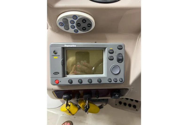 Slide: The Image of Control panel of a 2001 Regal Commodore 2760 boat with Raymarine chartplotter. - 11