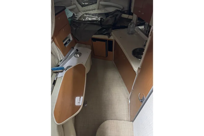 Slide: The Image of 2001 Regal Commodore 2760 cabin interior with kitchenette and seating area. - 13