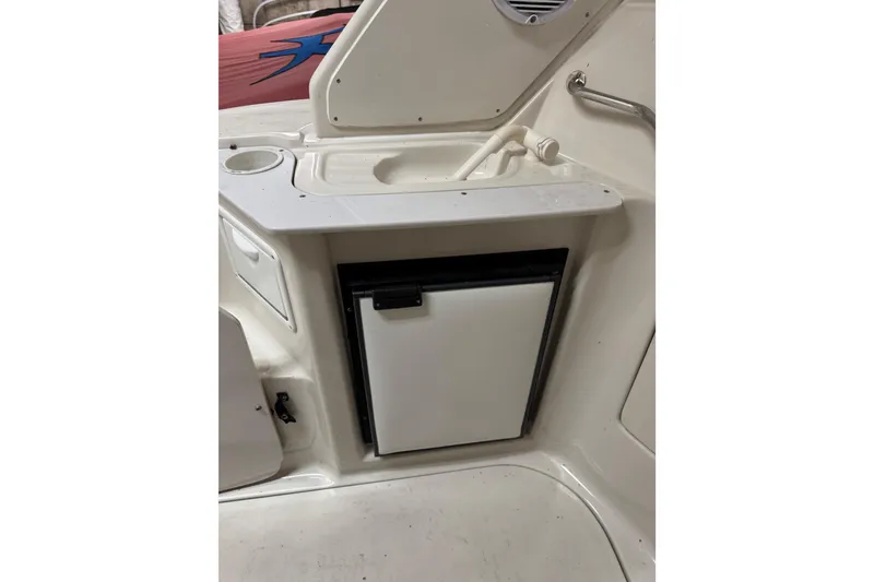 Slide: The Image of 2001 Regal Commodore 2760 boat interior with sink and mini fridge. - 24