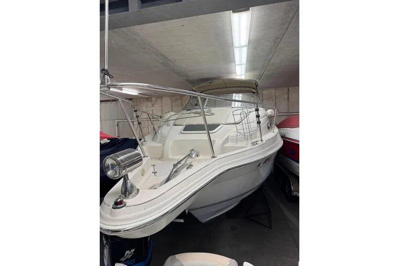 Slide: The Image of 2001 Regal Commodore 2760 boat in indoor storage, featuring sleek design and white exterior. - 5