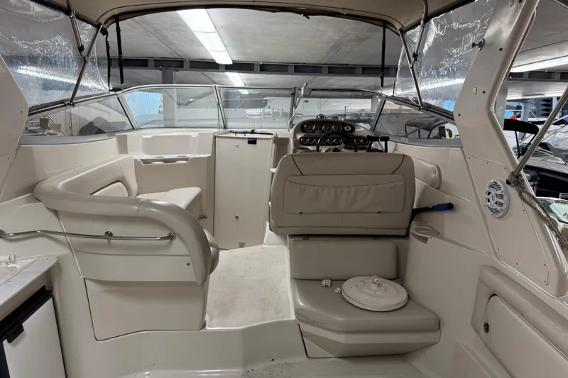 Slide: The Image of 2001 Regal Commodore 2760 boat interior with seating and control panel in a covered storage area. - 7