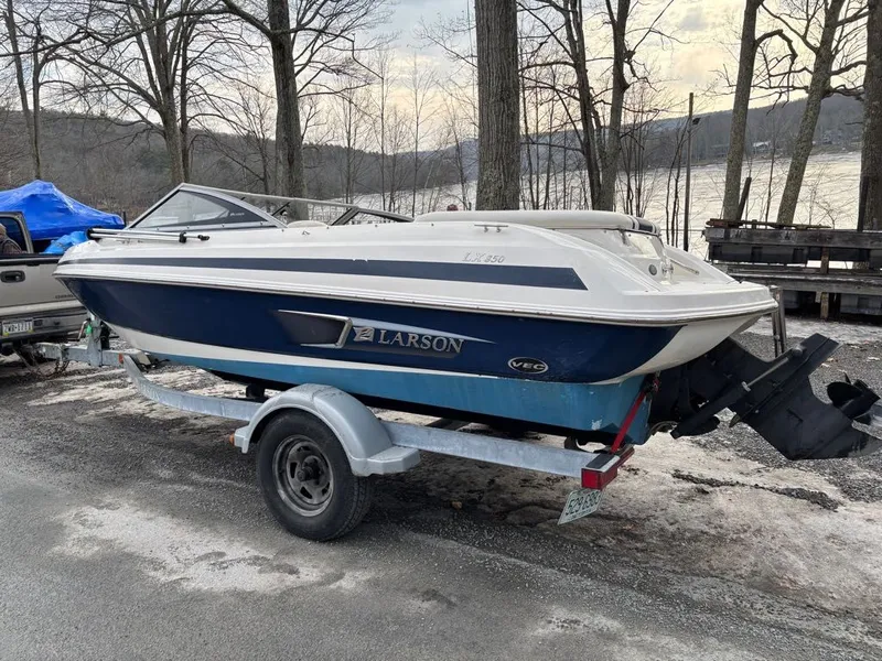 The Image of 2011 Larson 850 boat parked on trailer outdoors. - 1
