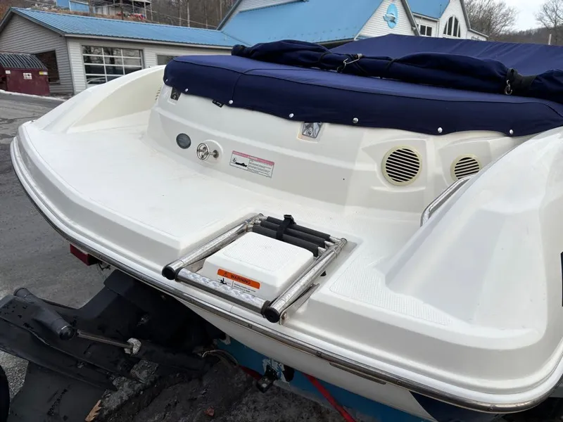 Slide: The Image of Rear view of a 2011 Larson 850 boat with blue cover. - 10