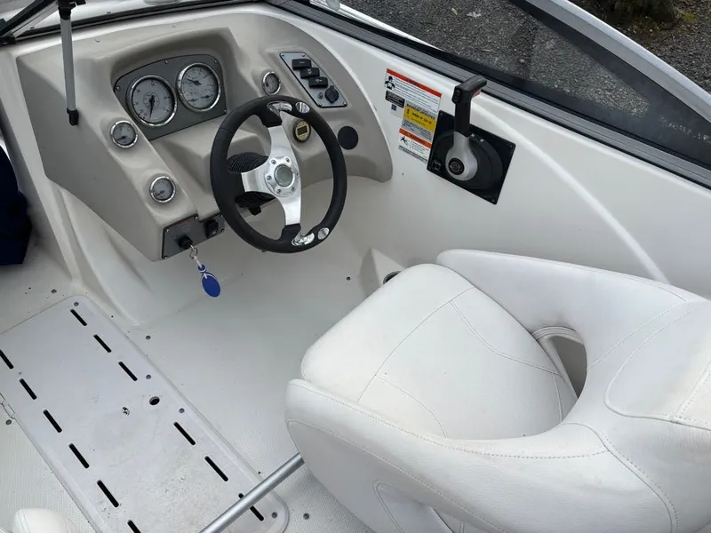 Slide: The Image of Interior of a 2011 Larson 850 boat with steering wheel and dashboard. - 11