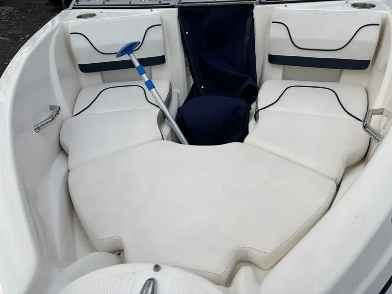 Slide: The Image of Interior of a 2011 Larson 850 boat with white seating. - 12