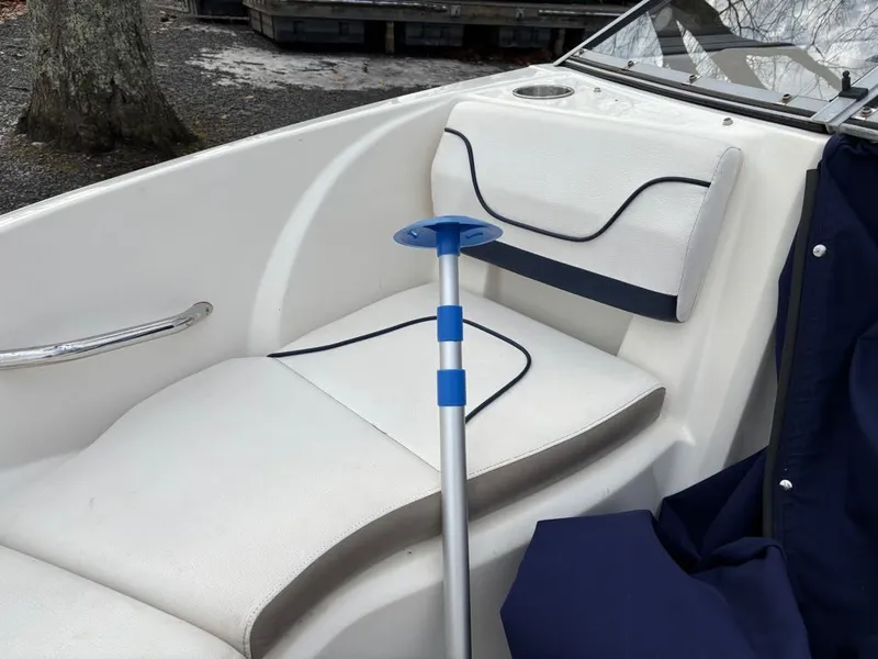 Slide: The Image of Interior of a 2011 Larson 850 boat with white seating. - 13