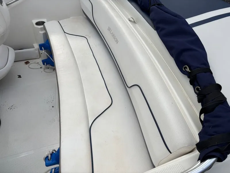 Slide: The Image of Interior of a 2011 Larson 850 boat with white seating. - 16